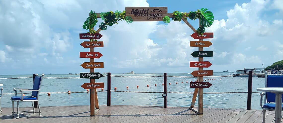 Scenic dock with directional signs for various water activities at NomadicStan. Perfect for beachgoe.