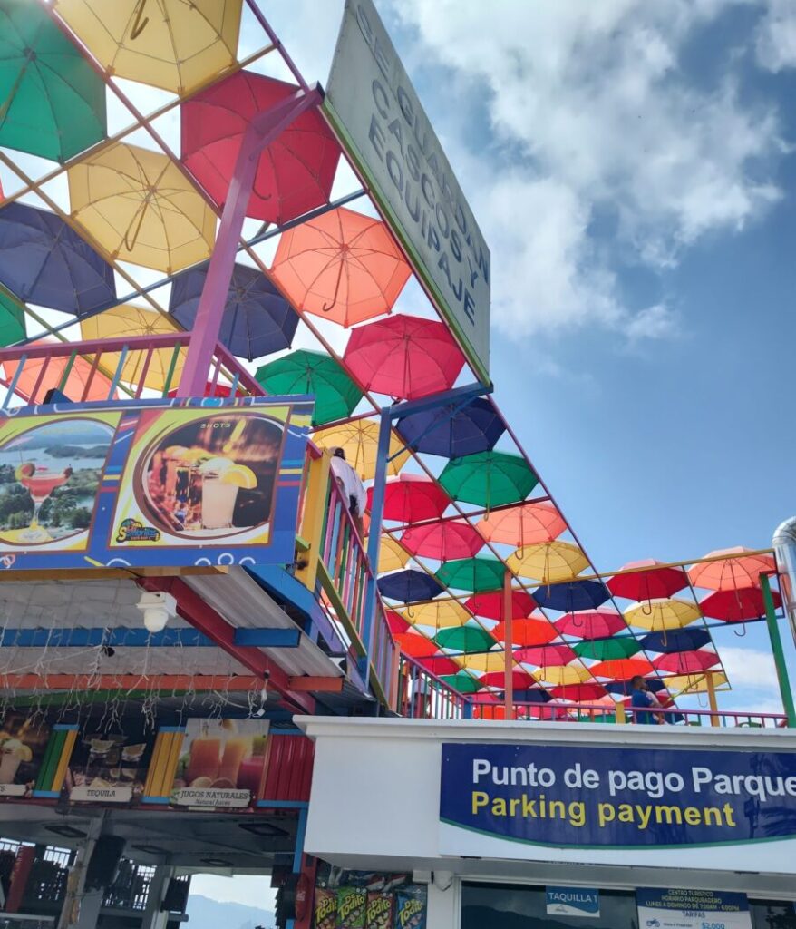 Vibrant umbrella canopy overhead at Guatapé amusement park, Colombia, creating a lively and scenic a.